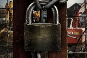 close-up of padlock on site gate