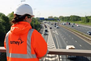 construction worker overlooking motorway