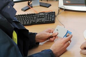 Someone's handing holding CSCS smart cards