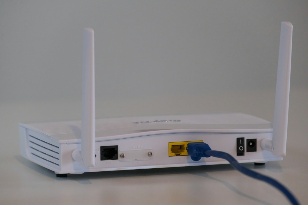 Rear view of a white wireless router with two antennas